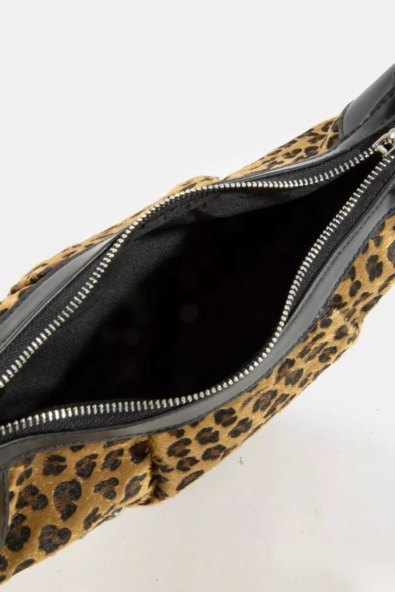 Leopard print fanny pack with a black interior on a white background
