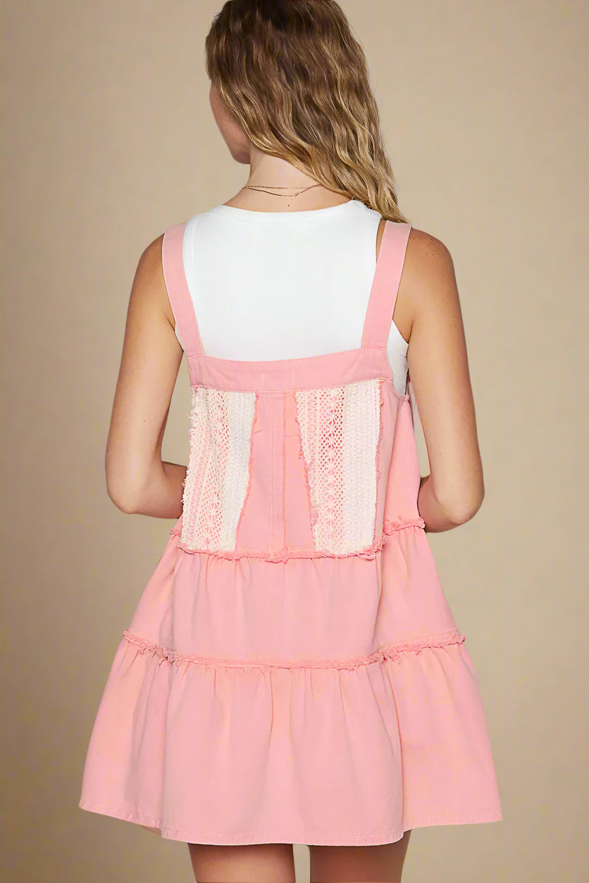 Pink dress with lace details on a plain background