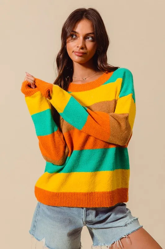 Woman wearing a colorful striped sweater against a beige background
