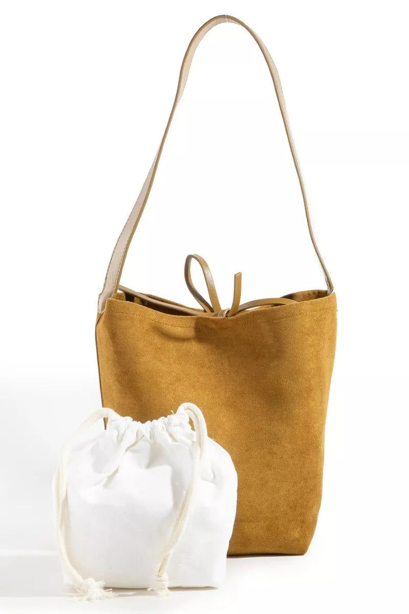 Mustard yellow tote bag and white drawstring bag on a white background