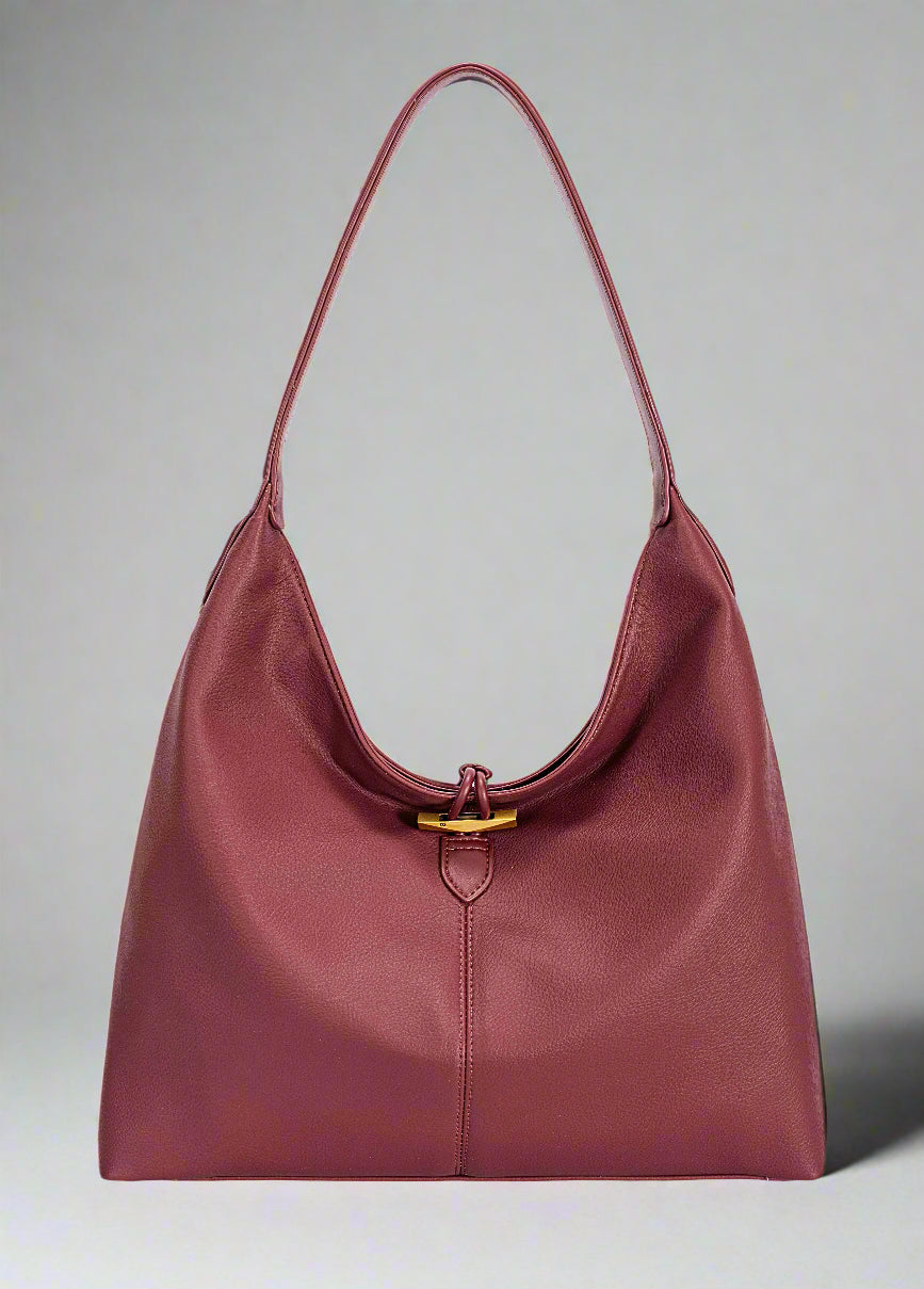 Maroon handbag with a gold clasp on a white background