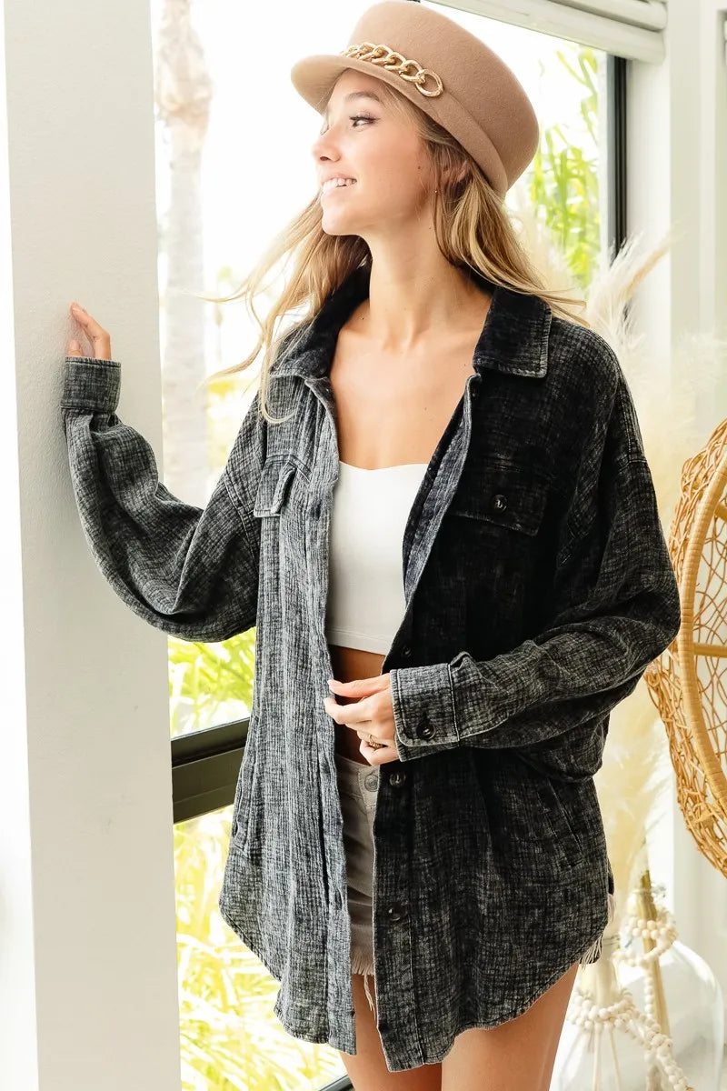 Woman wearing a dark denim jacket and beige hat indoors