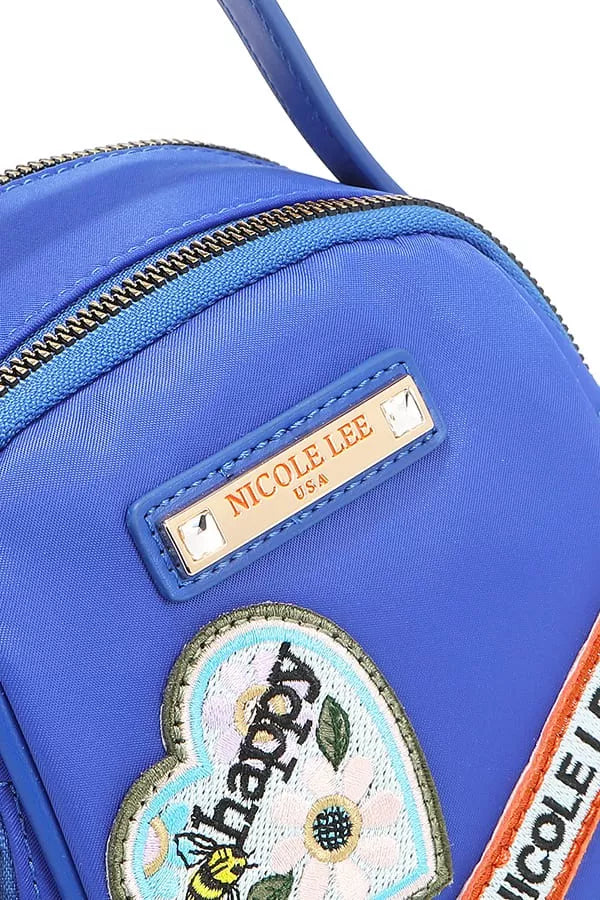 Blue bag with 'Nicole Lee' label and floral patch on a white background