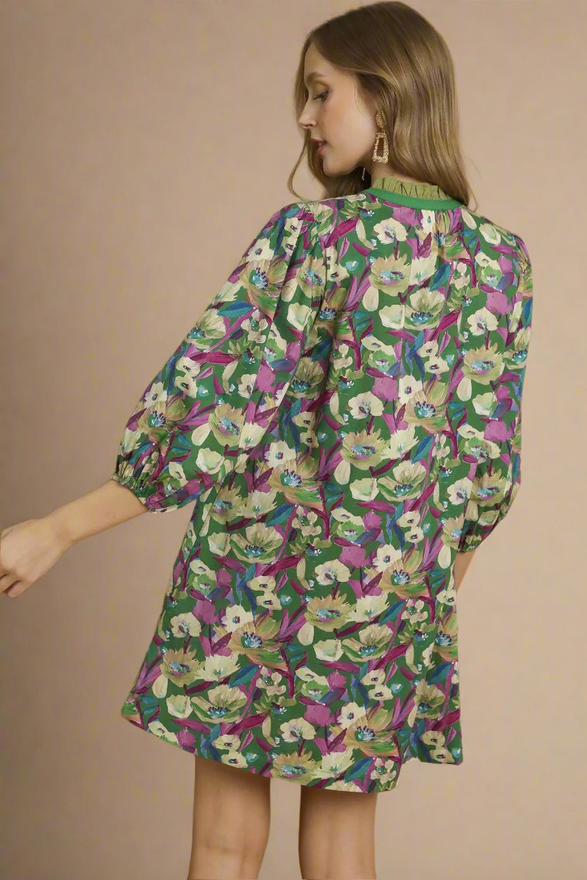Woman wearing a floral dress with green background