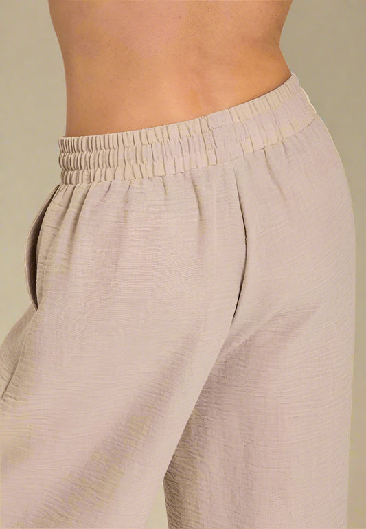 Beige pants with a close-up on a plain background