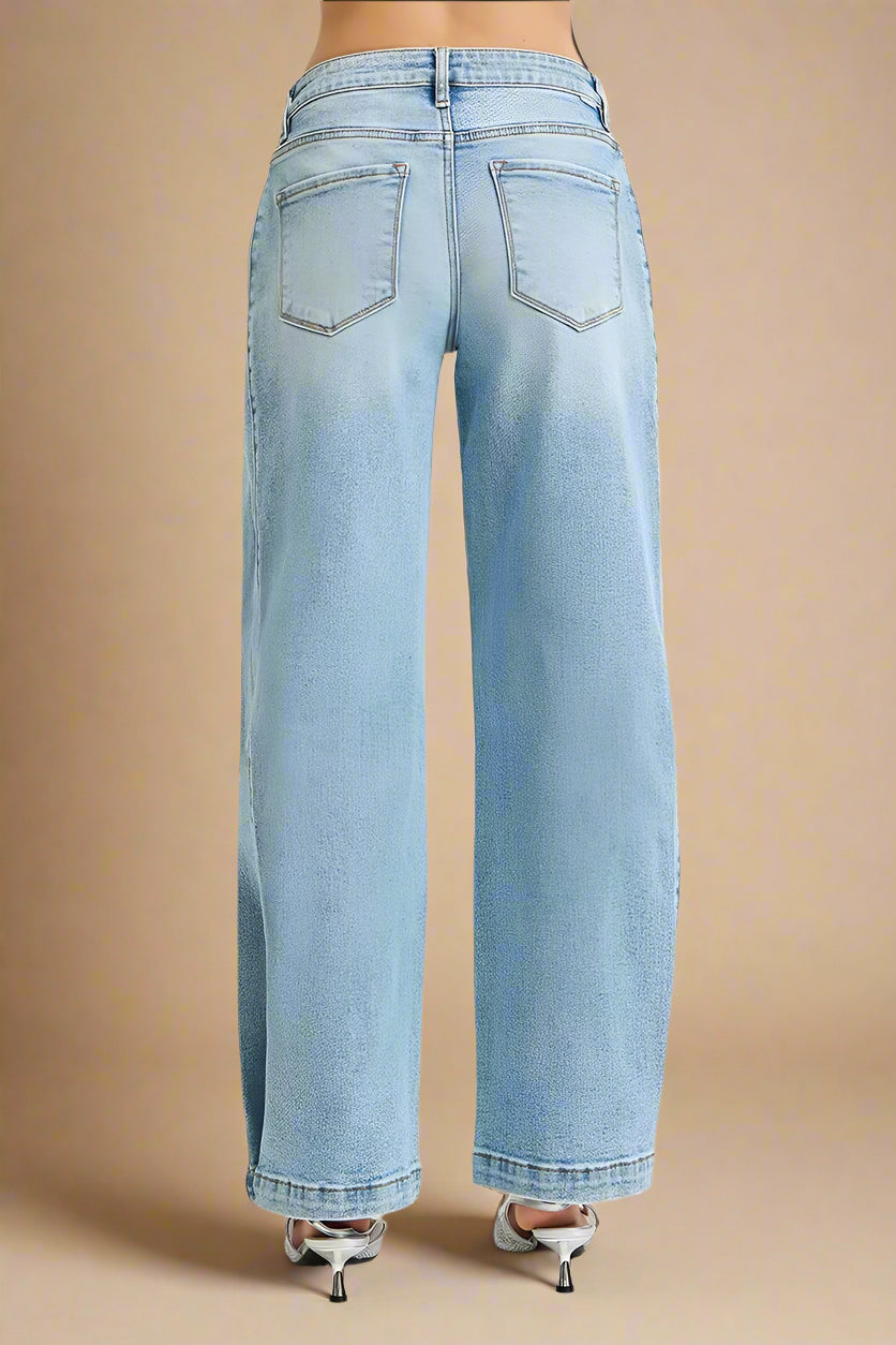 Light blue jeans worn by a person on a beige background