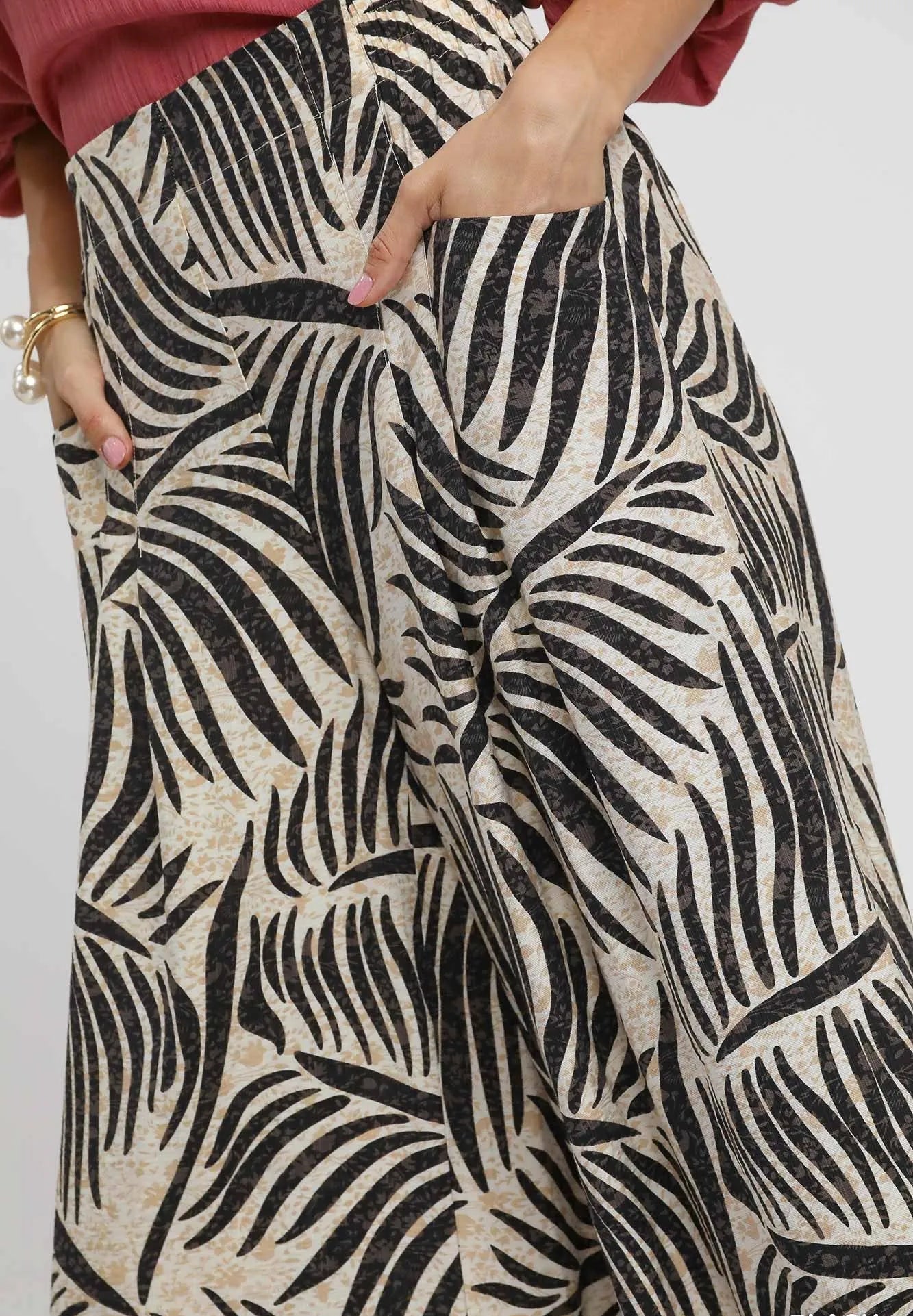 Zebra patterned pants worn by a person on a plain background