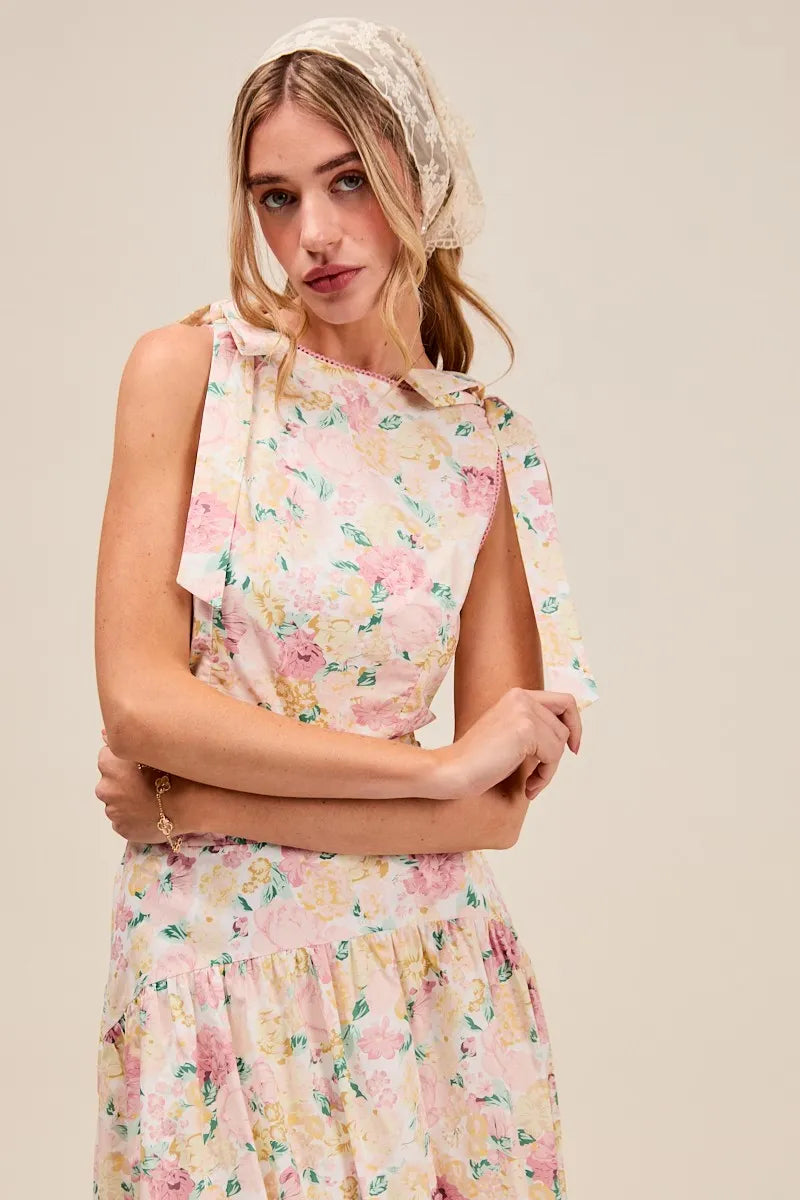 Woman wearing a floral dress with a beige background