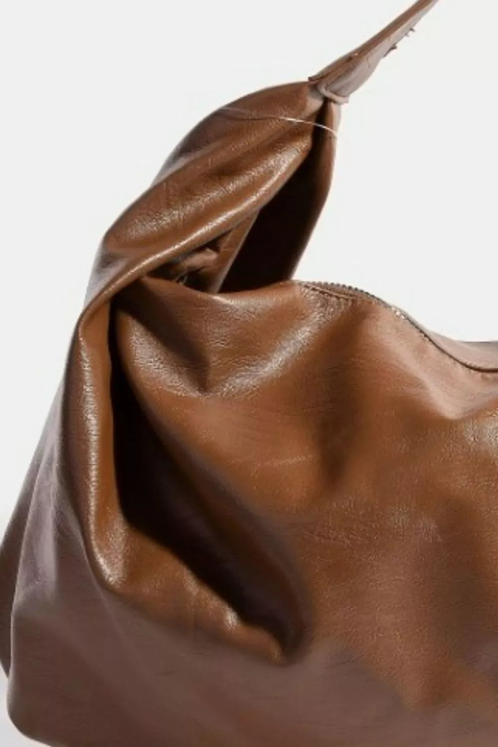 Brown leather handbag on a white background