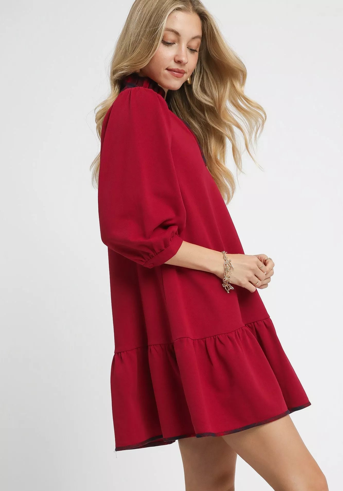 Woman wearing a red dress with a plain background