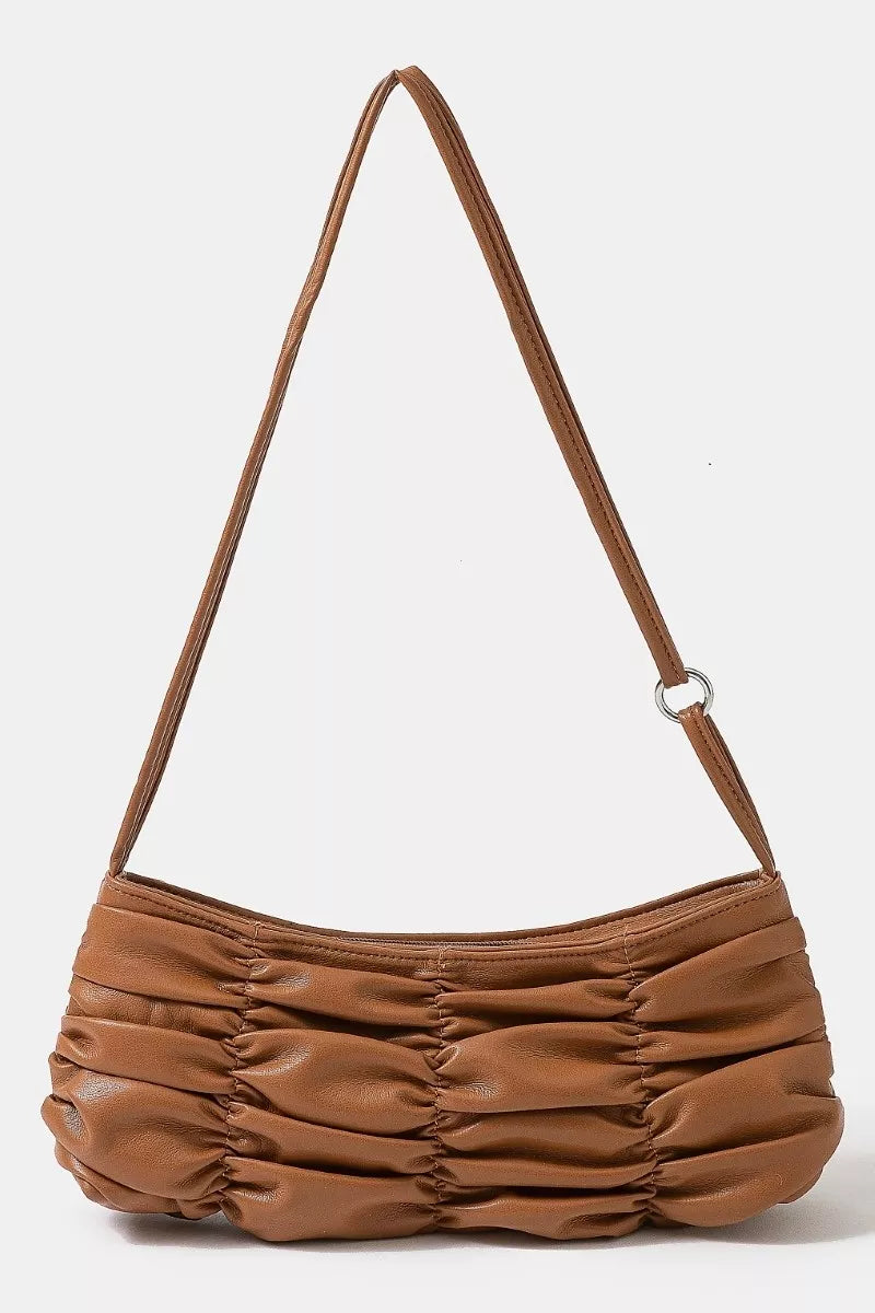 Brown ruched handbag with a strap on a white background
