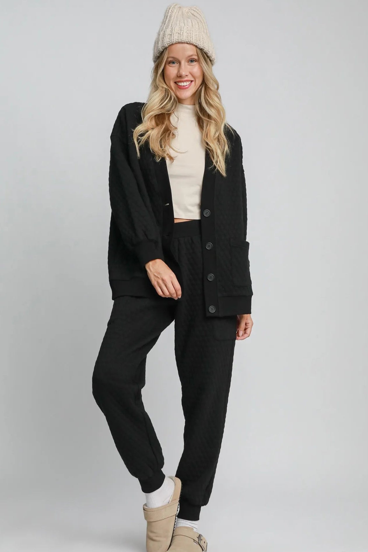 Woman wearing a black outfit with a white background