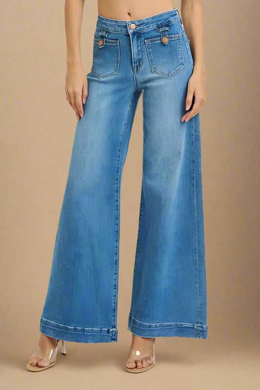Blue jeans worn by a person on a white background