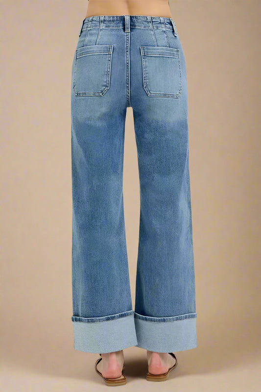Blue jeans with a rolled hem on a white background
