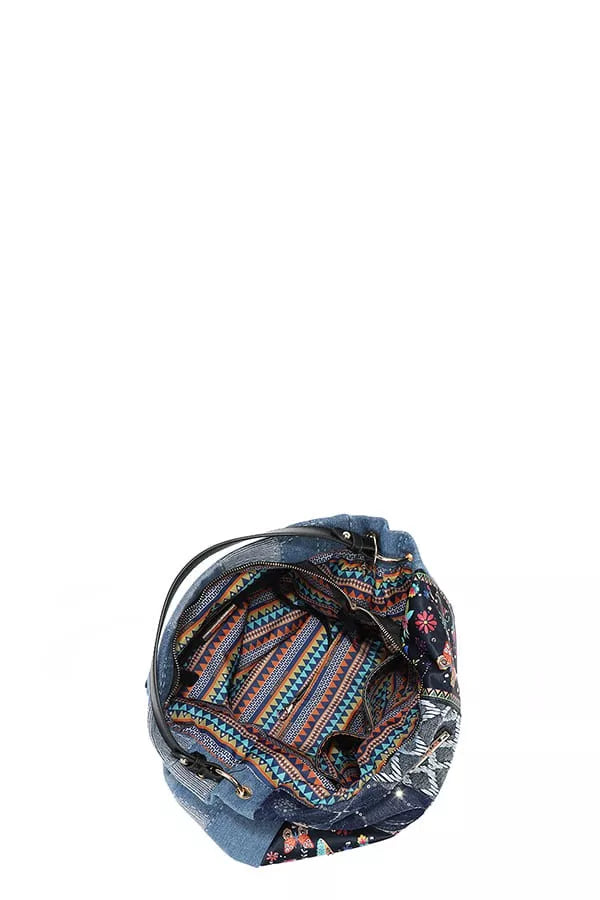 Floral patterned bag with denim design on a white background