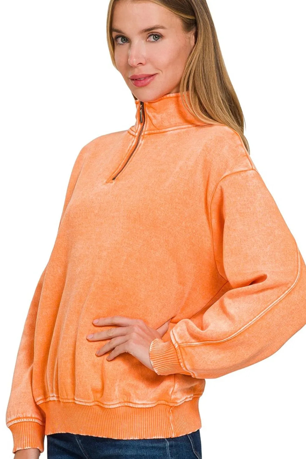 Woman wearing an orange sweatshirt on a white background