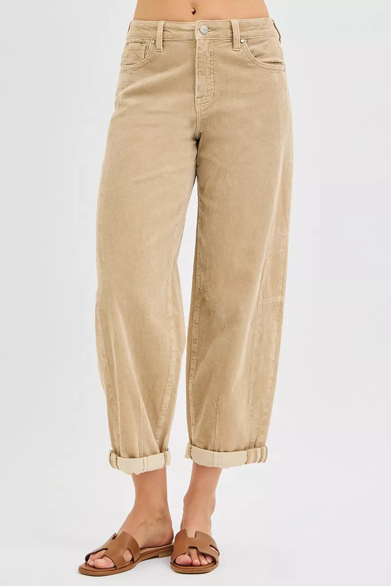 Beige pants worn by a person on a white background