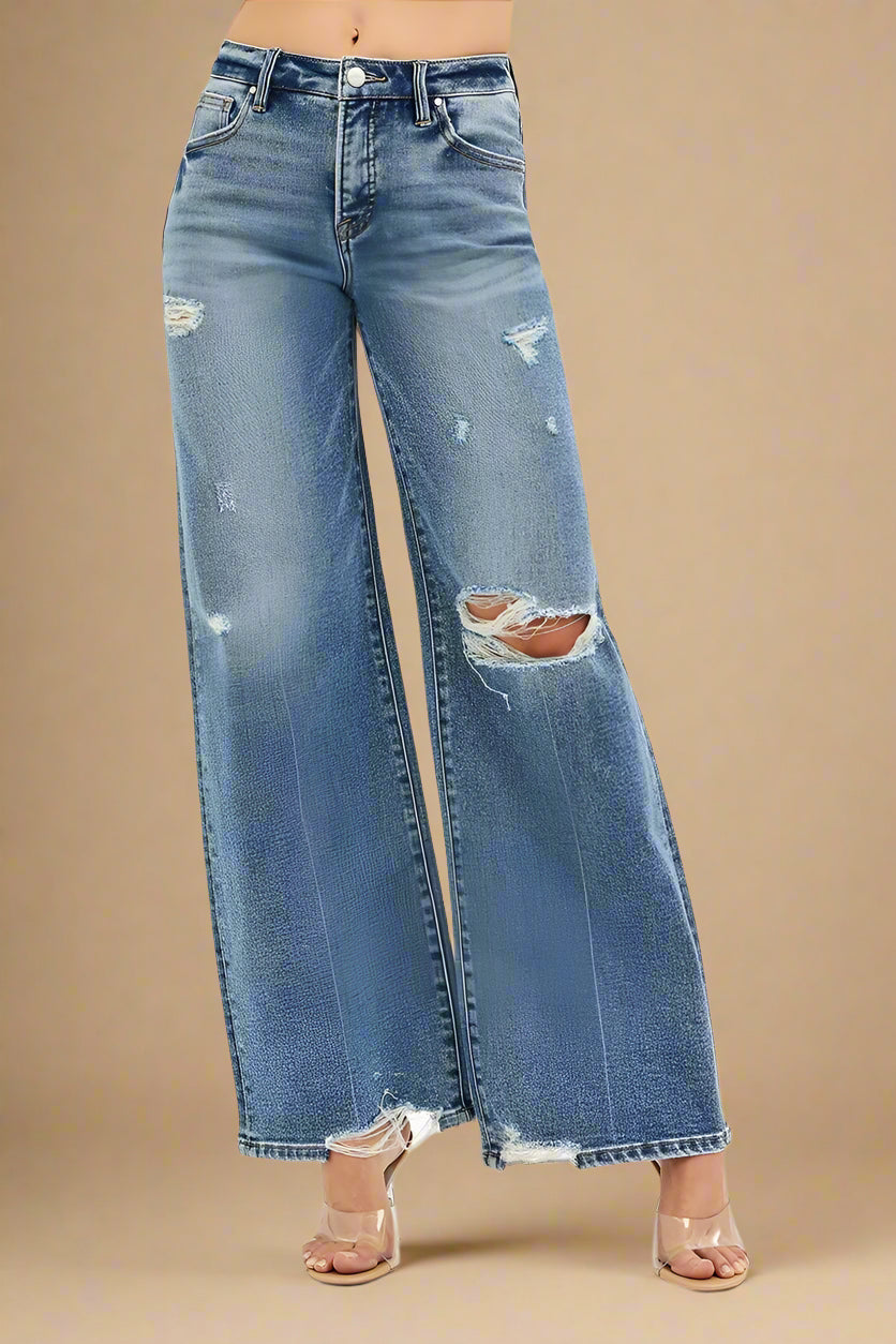 Distressed blue jeans on a white background