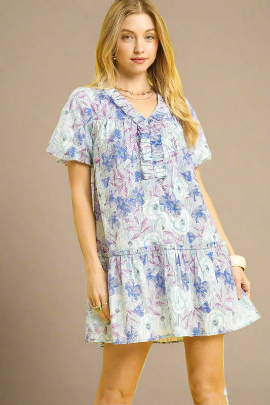 Woman wearing a floral dress against a beige background