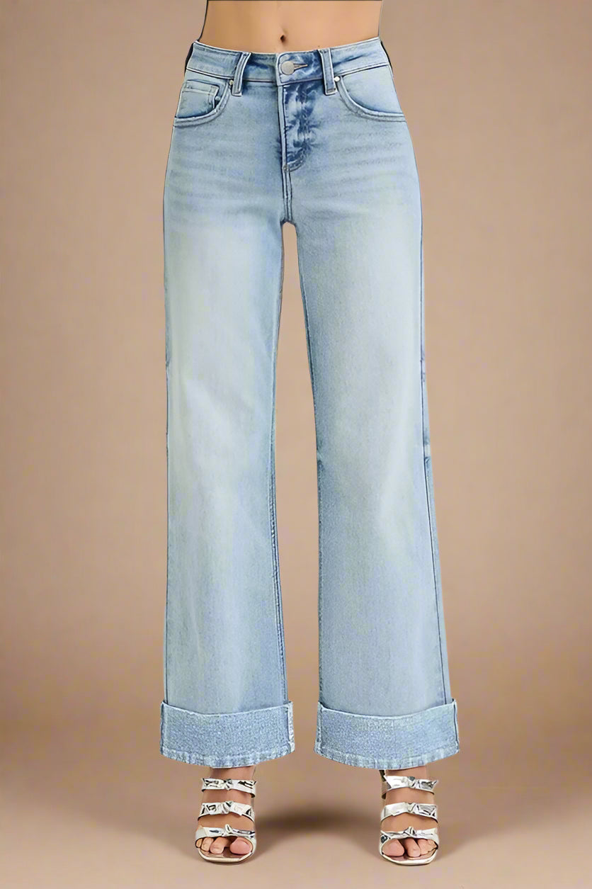 Light blue wide-leg jeans on a beige background