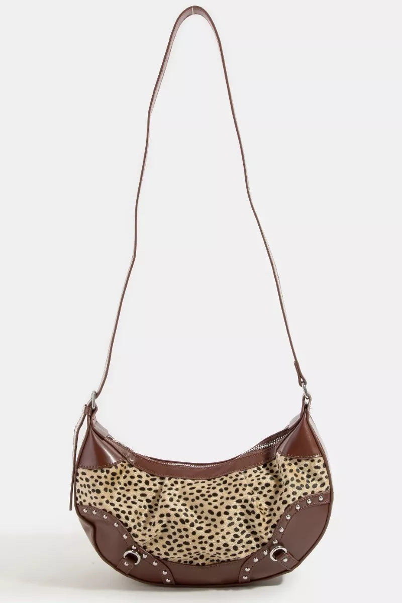 Brown handbag with leopard print accents on a white background