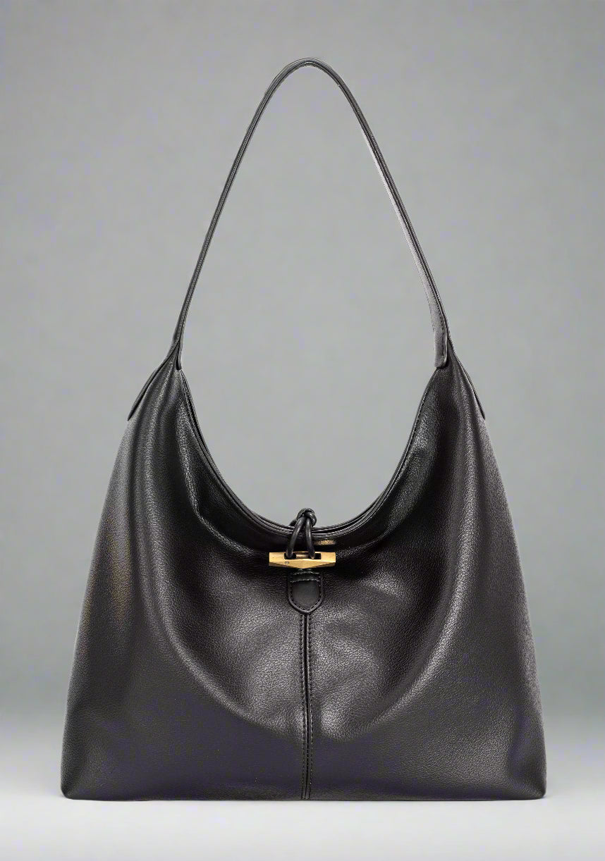 Black leather handbag with a gold clasp on a white background