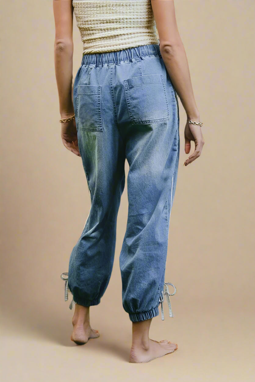 Person wearing blue jeans on a beige background