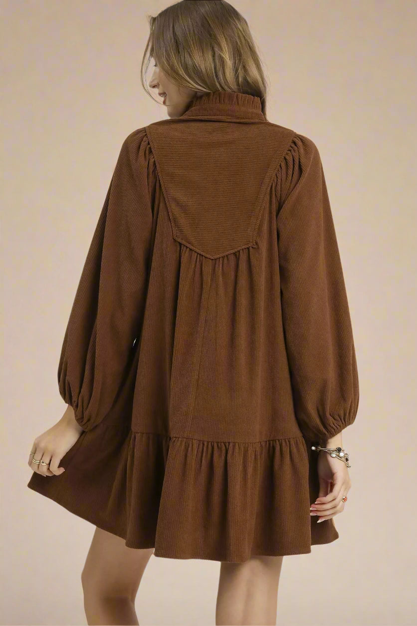 Brown dress worn by a person on a white background