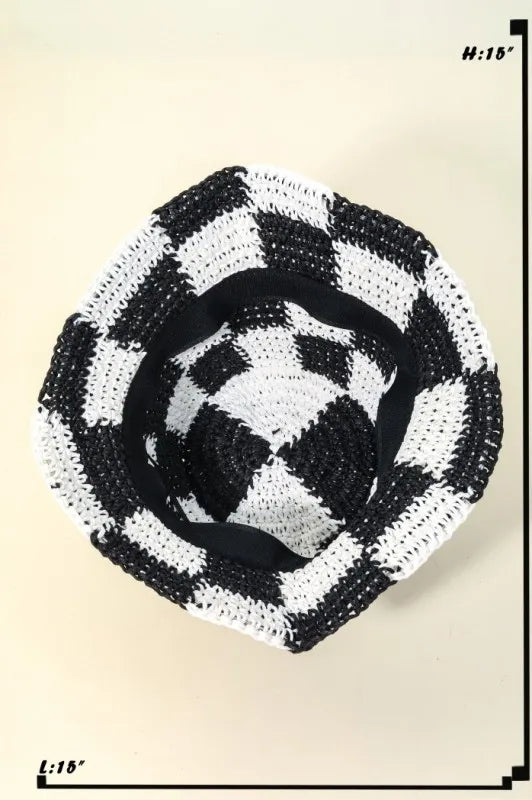 Black and white checkered woven mat on a beige background