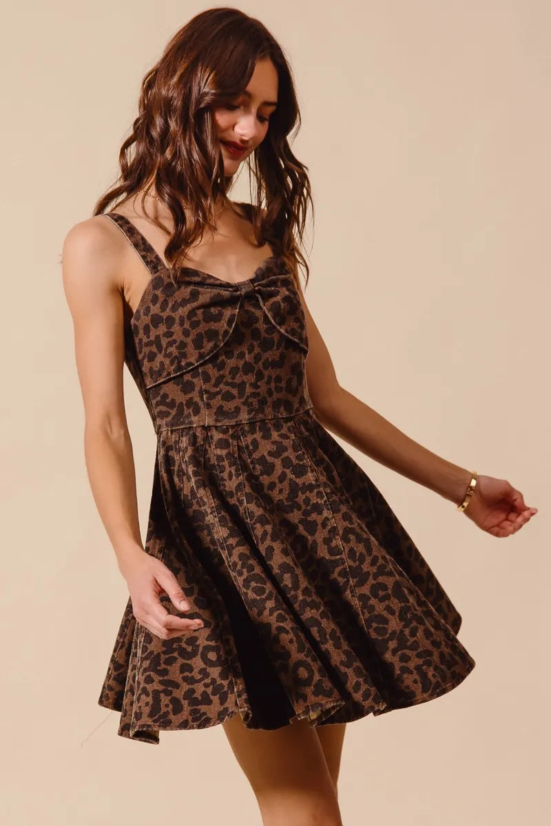 Woman wearing a leopard print dress against a beige background