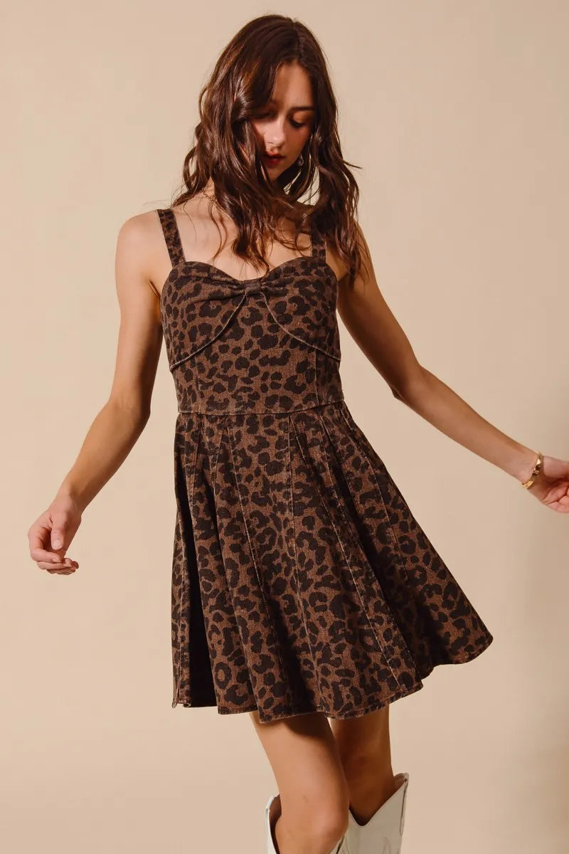 Woman wearing a leopard print dress against a beige background
