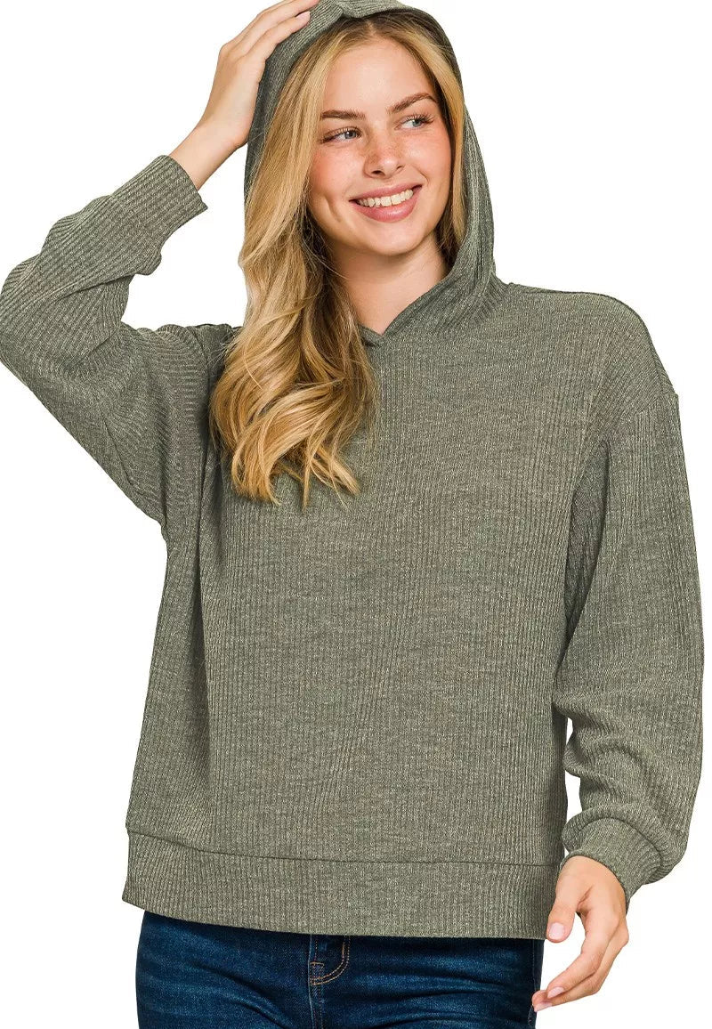 Woman wearing a dark olive green hoodie on a white background