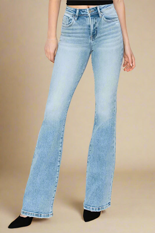 Light blue jeans worn by a person on a beige background