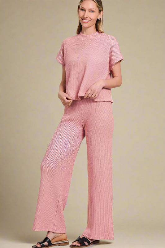 Woman wearing a light rose outfit on a beige background