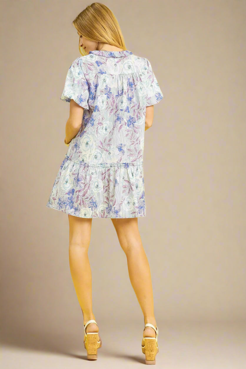 Woman wearing a floral dress on a beige background