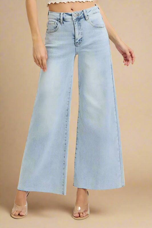 Light blue wide-leg jeans worn by a person on a white background