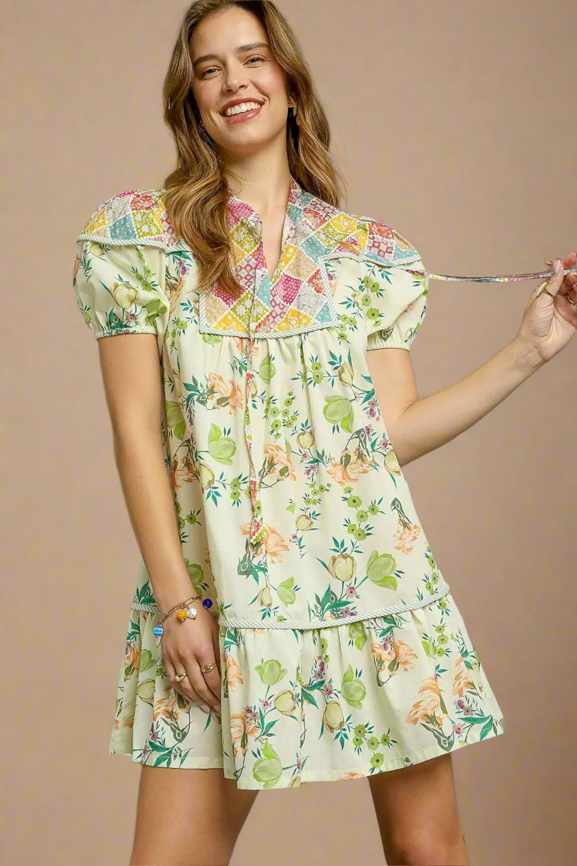 Woman wearing a floral dress against a beige background