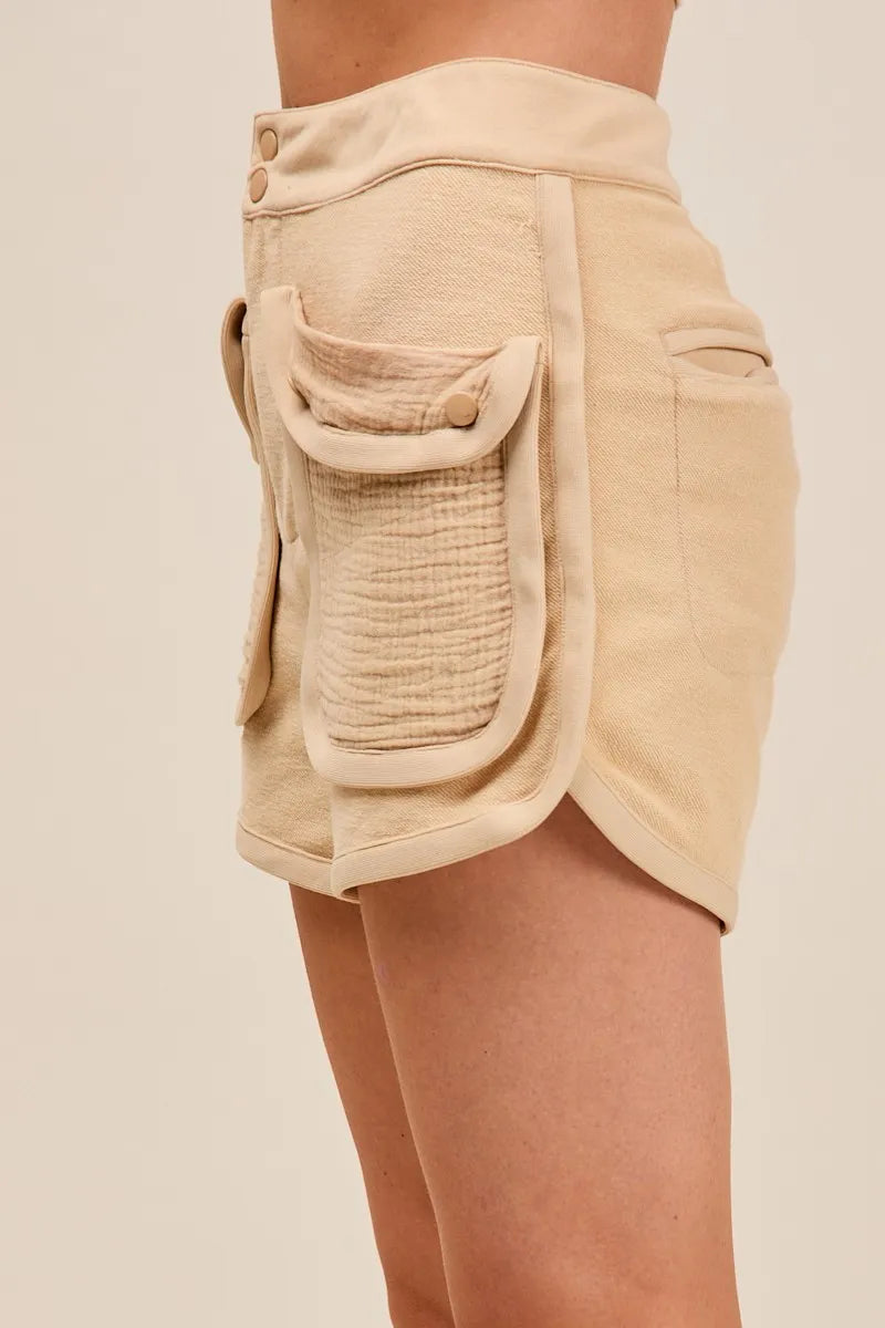 Beige shorts with front pocket on a beige background