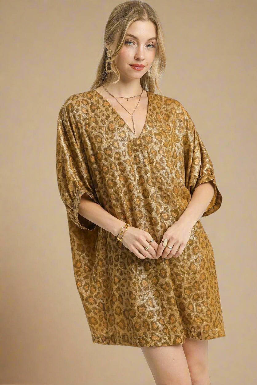 Woman wearing a brown leopard print dress on a beige background