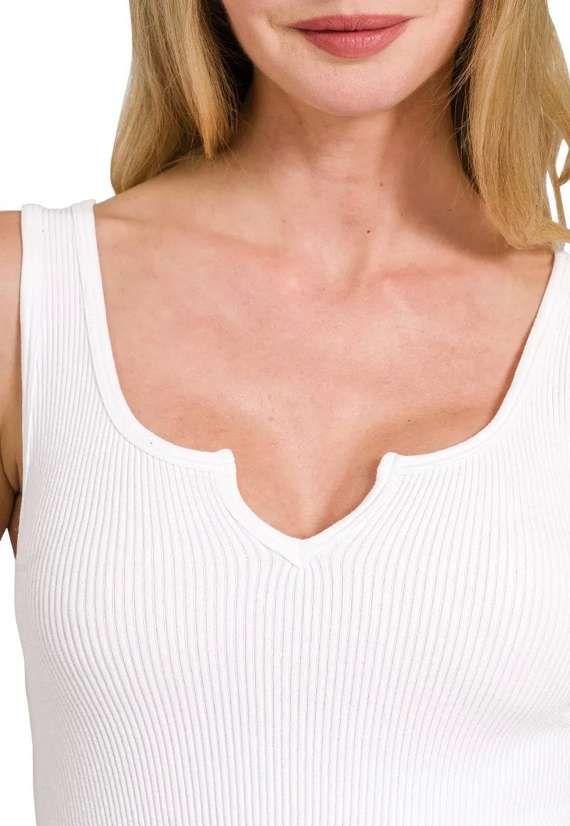 Close-up of a person wearing a white tank top
