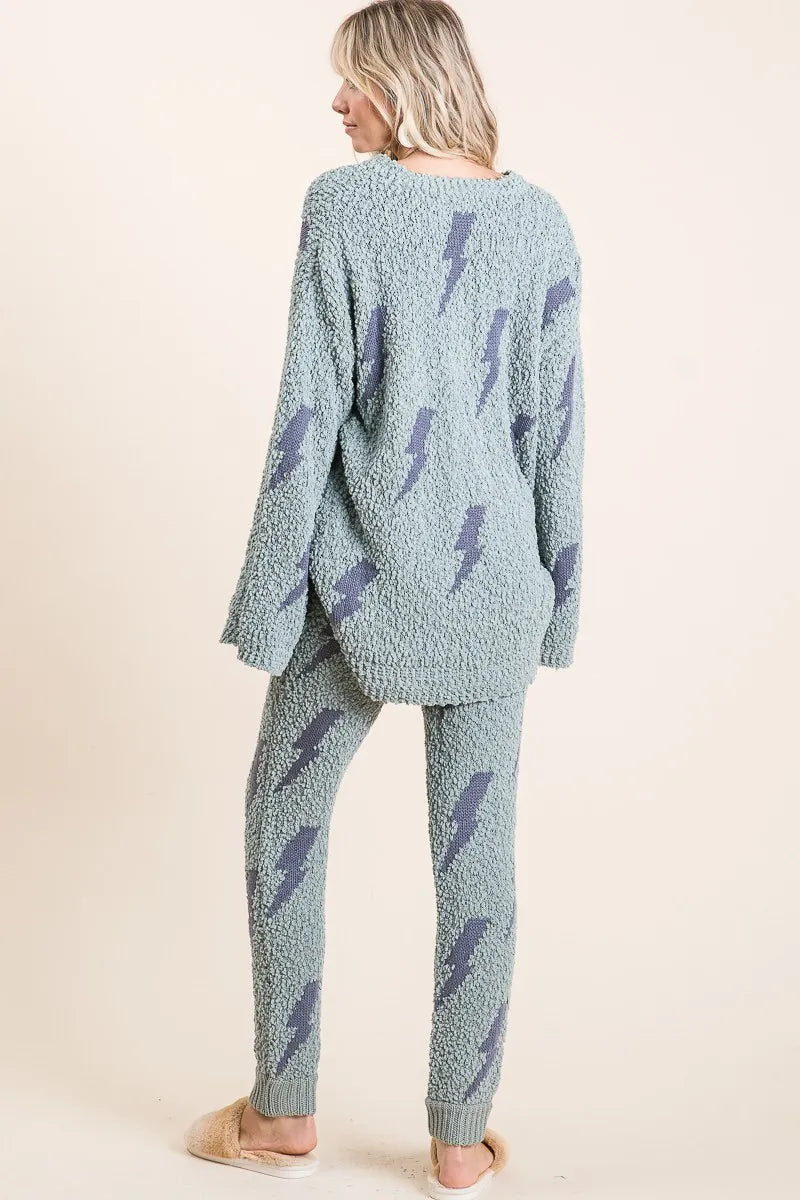 Woman wearing a light blue pajama set with lightning bolt pattern on a beige background