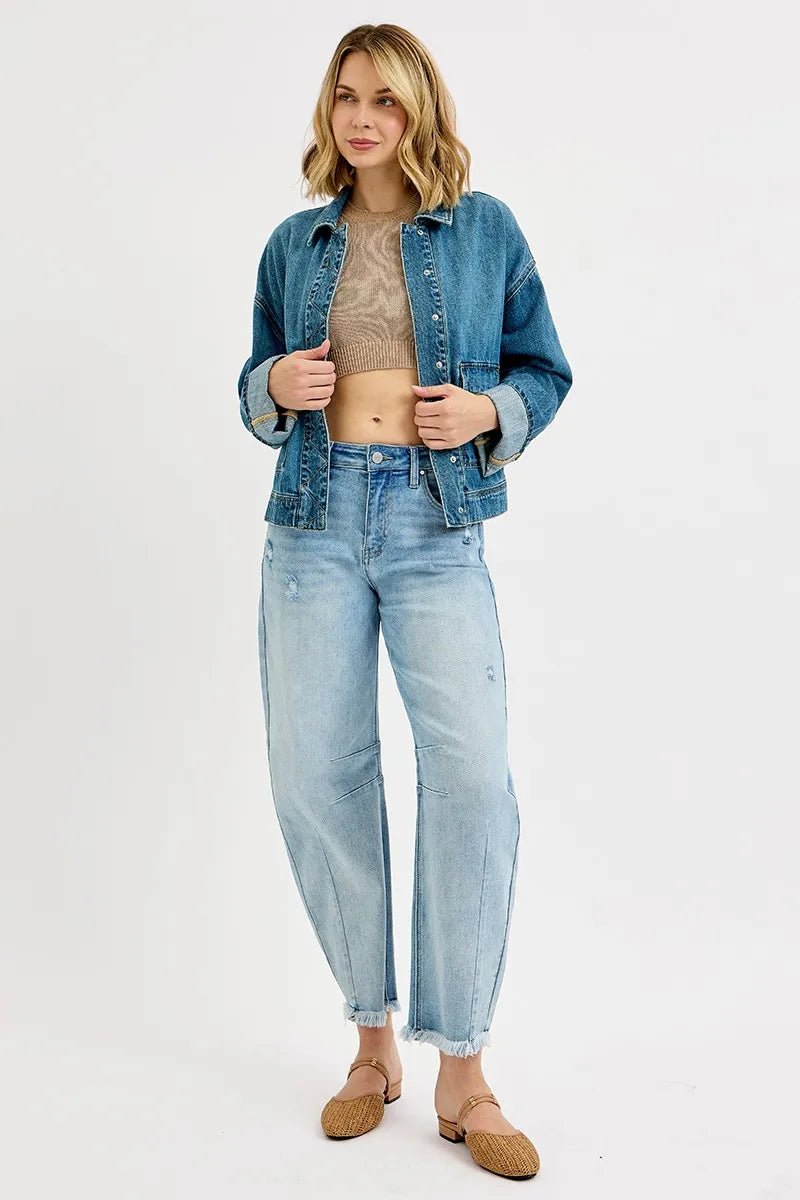 Woman wearing a denim jacket and jeans on a white background