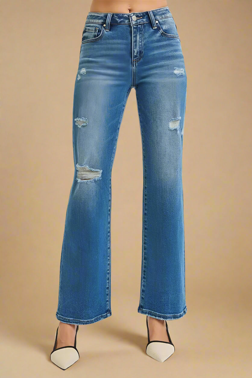 Blue jeans with slight distressing on a white background
