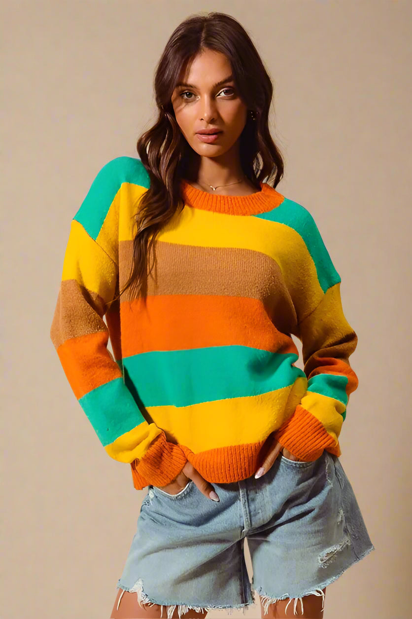 Woman wearing a colorful striped sweater against a beige background