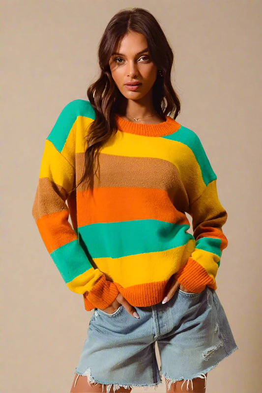 Woman wearing a colorful striped sweater against a beige background
