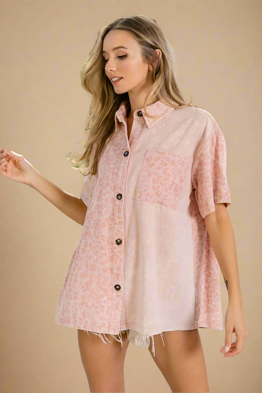 Woman wearing a pink patterned shirt on a beige background
