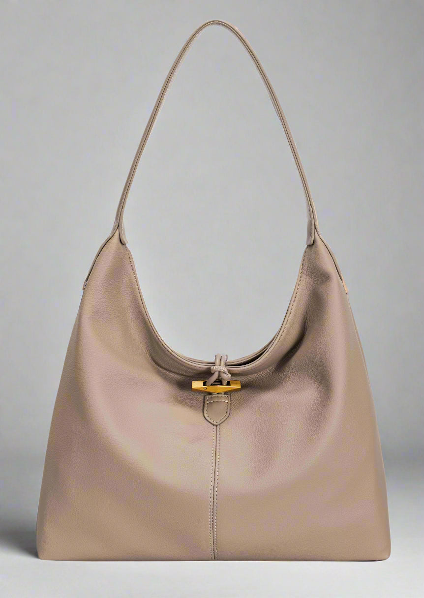 Beige handbag with a gold clasp on a white background