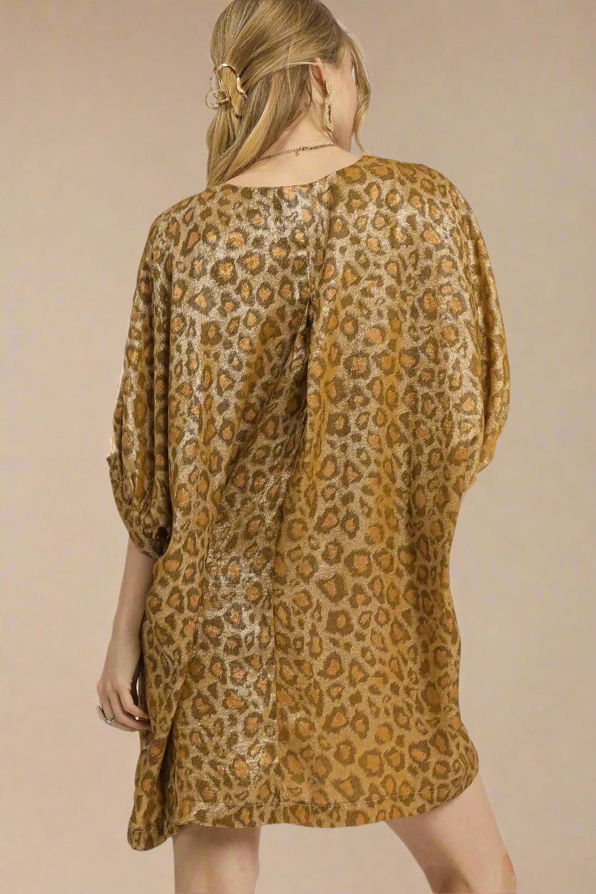 Woman wearing a leopard print dress on a white background