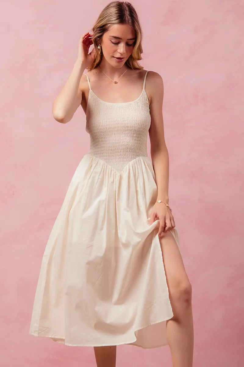 Woman wearing a white dress with a pink background