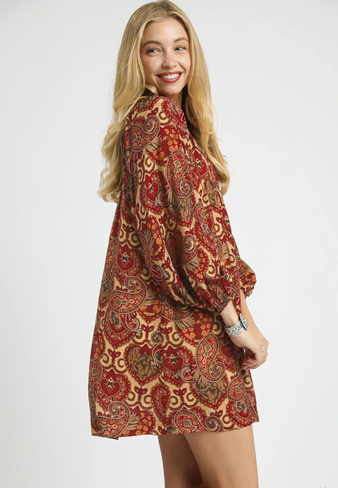 Woman wearing a patterned dress on a white background